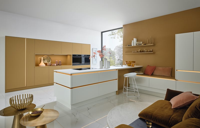 Caramel tones are very on trend. Soft Lack door style in caramel soft matt and white soft matt with a manganese bronze handle track, from Kube Kitchens