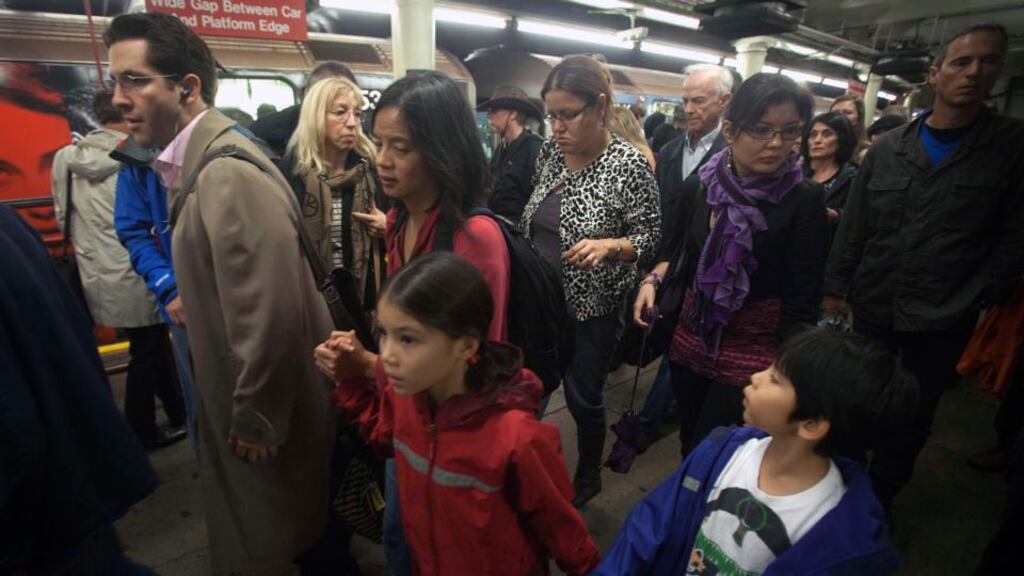 Passengers get off a subway train at Times Square in New York yesterday. Photograph: Carlo Allegri/Reuters.