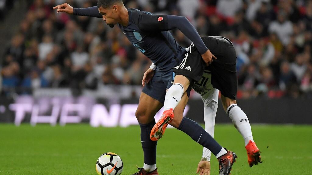 England’s Ruben Loftus-Cheek in action with Germany’s Mesut Ozil. Photograph: Reuters