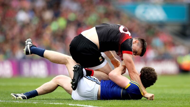 Mayo’s Jason Doherty and Tadhg Morley of Kerry clash at the start of the game. Photograph: Ryan Byrne/Inpho
