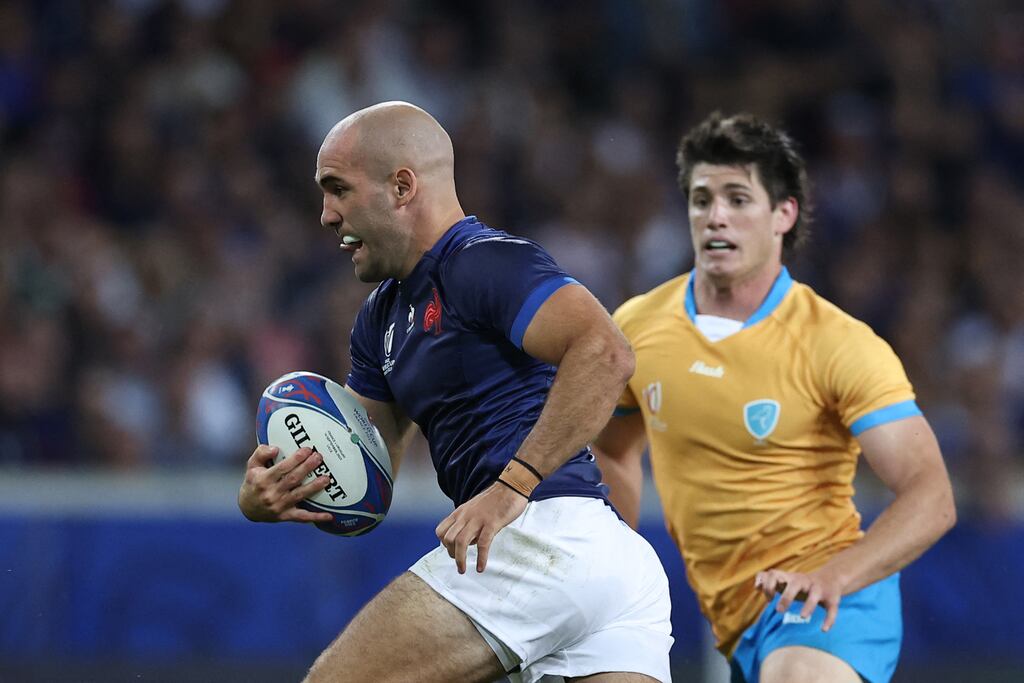 France's scrum-half Maxime Lucu (L) runs with the ball during the France 2023 Rugby World Cup Pool A match between France and Uruguay at Pierre-Mauroy stadium in Lille, northern France on September 14, 2023. Photograph: Franck Fife via Getty Images.