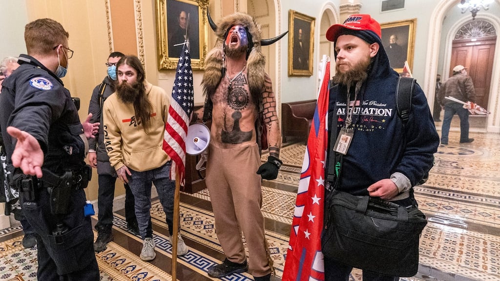 Supporters of Donald Trump are confronted by a Capitol police officer outside the senate chamber on January 6h, 2021. Photograph: AP Photo/Manuel Balce Ceneta