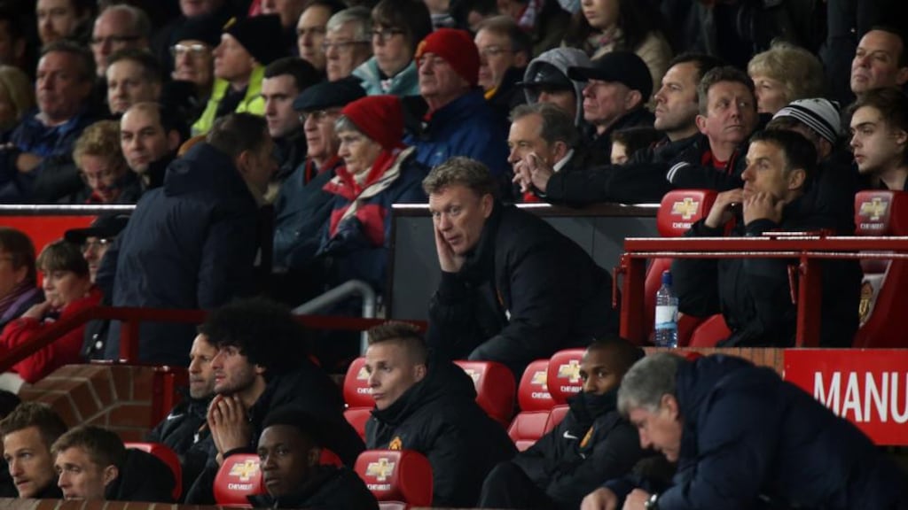 Manchester United manager David Moyes sits in the dugout during the Premier League match against Manchester City at Old Trafford. Photograph: Peter Byrne/PA