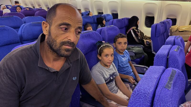 Mohammed Mqat with two of his children on the evacuation flight to Abu Dhabi, United Arab Emirates in August. Photograph: Ismaeel Naar/ The New York Times