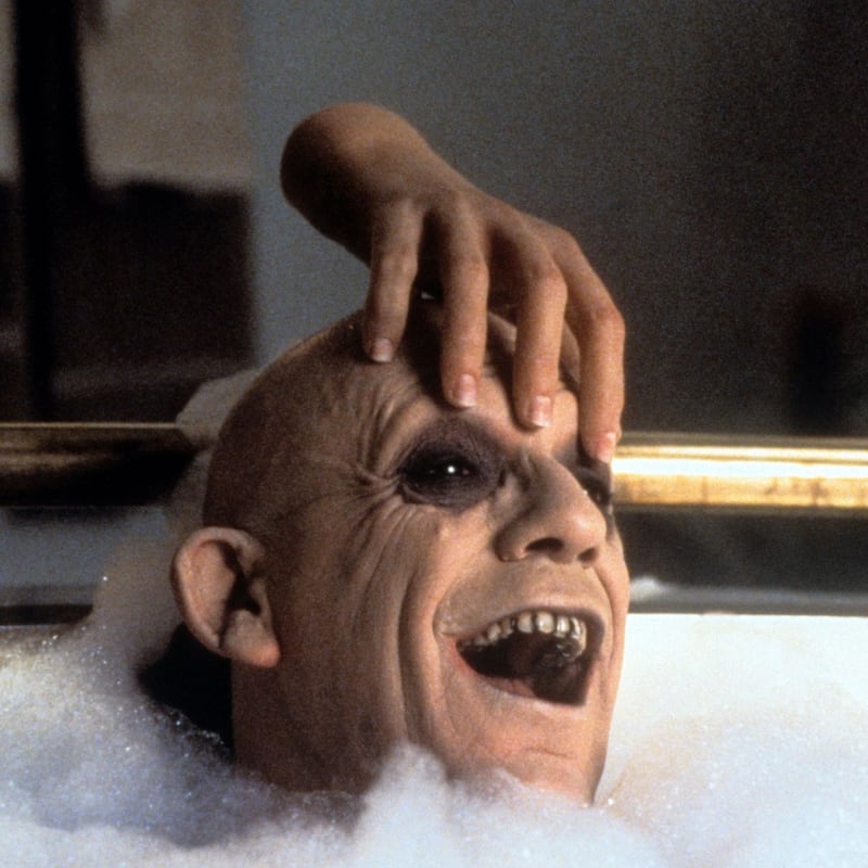The Thing rubbing Christopher Lloyd’s head in the bathtub in a scene from the film ‘Addams Family Values’, 1993. Photograph: Paramount/Getty