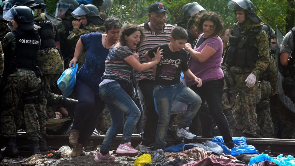 Migrants break through the cordon of Macedonian special police forces to cross into Macedonia near the southern city of Gevgelija on Saturday. Photograph: Georgi Licovski/EPA