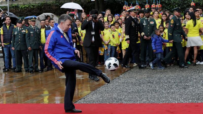 Colombia’s outgoing president Juan Manuel Santos during a ceremony handing the Colombian flag to the national soccer team’s captain prior to its participation in the World Cup in Russia, in Bogota. Photograph: Henry Romero