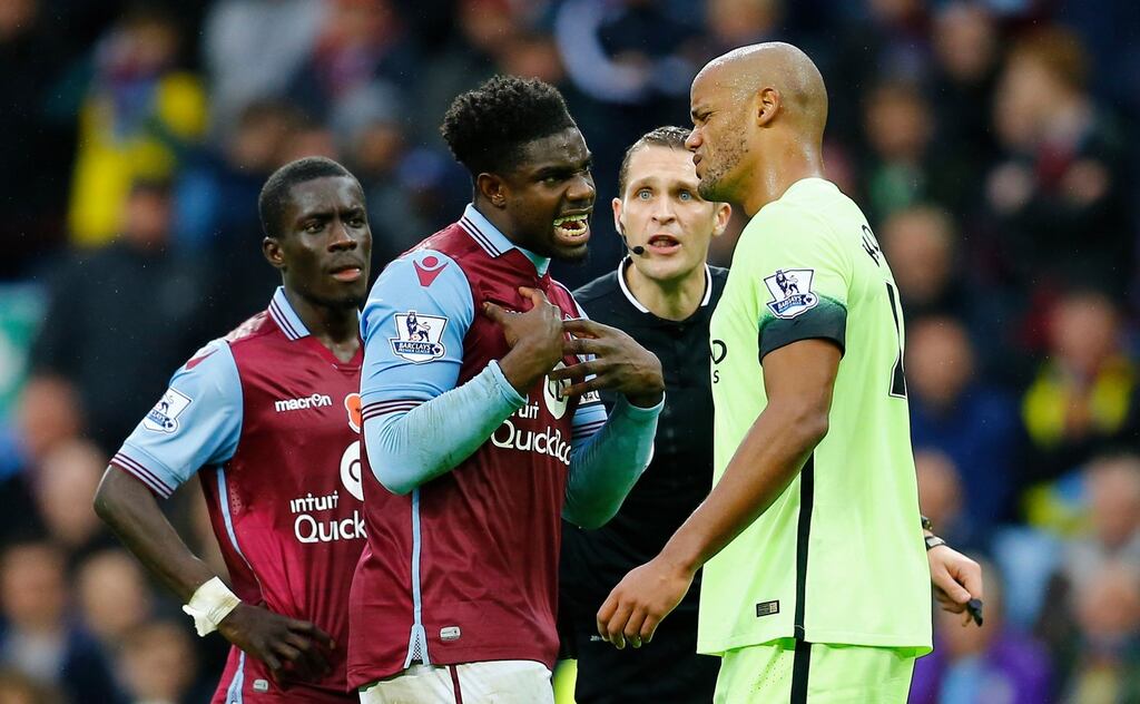 Aston Villa’s man of the match Micah Richards reacts with his former captain Vincent Kompany as referee Craig Pawson looks on. Photograph: Darren Staples/Reuters