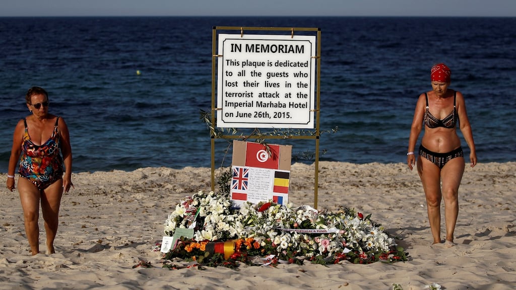 Tourists pass a plaque dedicated to victims on the beach of the Imperial Marhaba resort, on the first anniversary of an attack by a gunman at the hotel in Sousse, Tunisia on June 26th, 2016. File photograph: Zohra Bensemra/Reuters