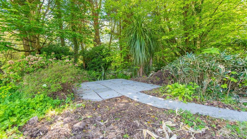 The patio by the stream at the boundary of the garden