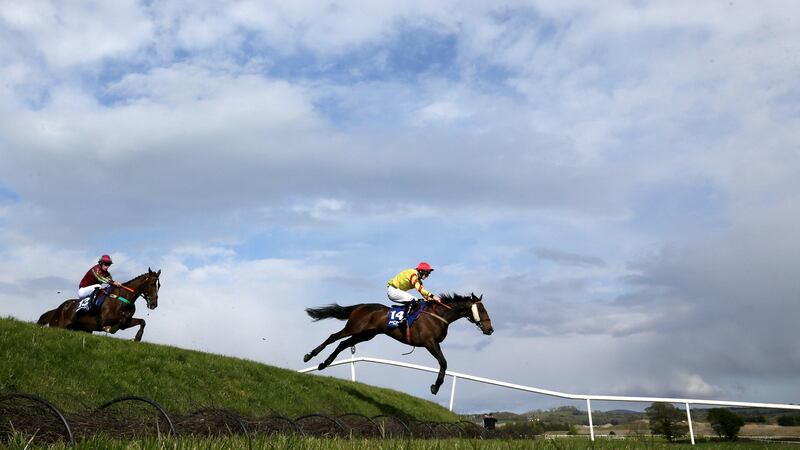 Barry Walsh riding Singing Banjo on their way to winning the Mongey Communications La Touche Cup Cross-Country Chase during day three of the Punchestown Festival. Photograph: Brian Lawless/PA Wire