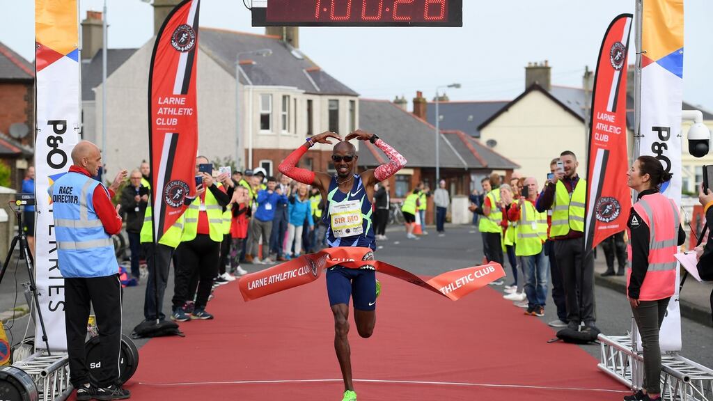Mo Farah crossing the finish line after taking part in the Antrim Coast Half Marathon. Photograph: PA