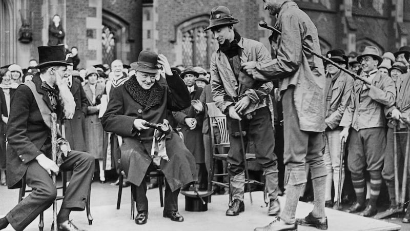 Winston Churchill is presented with a green hat and clay pipe by students during rag week at Queen’s University, Belfast in 1926. Photograph: Topical Press Agency/Getty Images