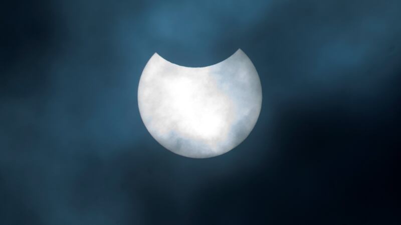 A partial solar eclipse as seen over Canary Wharf in London. Photograph: Victoria Jones/PA Wire