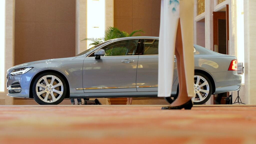 A waitress stands next to a Volvo S90 displayed at a panel discussion about self-driving cars at Diaoyutai State Guesthouse in Beijing on April 7th Photograph: Reuters
