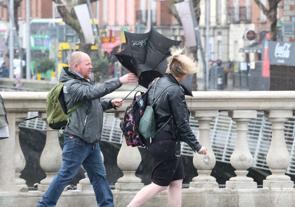 People struggle with the poor weather conditions in Dublin city centre on Sunday. Photograph: Stephen Collins/Collins Photos