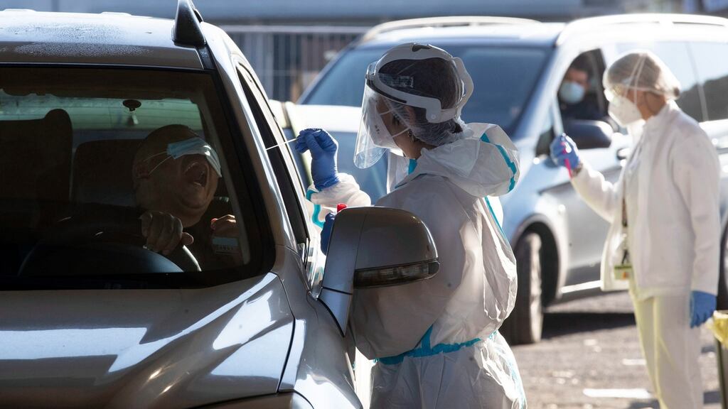 Motorists wait in line for their swab samples to be taken for Covid-19 testing by health workers at the drive-in that has been set up at Palmiro Togliatti road in Rome, Italy on Saturday. Photograph: Massimo Percossi/EPA
