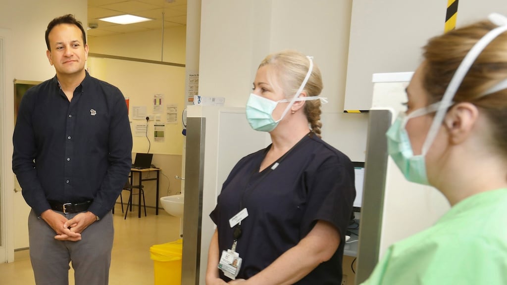 Taoiseach Leo Varadkar, and nurses Leona Byrne and Sarah Totney at the Covid-19 Community Assessment Hub in DCU in Dublin. Photograph: Leon Farrell/Photocall Ireland