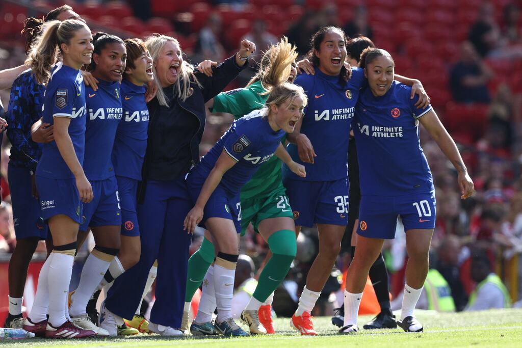Chelsea manager Emma Hayes celebrates with her players at the final whistle of the Women's Super League football match against Manchester United at Old Trafford. Chelsea won the game 6-0 to secure their fifth league title in a row. Photograph: Darren Staples/AFP via Getty Images