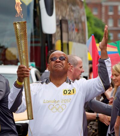 Darren's father Tony Sutherland carries the Olympic Torch during the London 2012 Olympic Torch Relay. Photograph: Morgan Treacy/Inpho