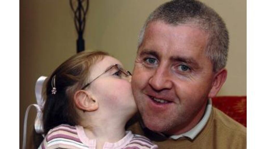 Donal Fenton gets a kiss from his daughter, Aimee, in their home in Ladysbridge, Co Cork. Donal donated one of his kidneys last July in a bid to save his three-year-old daughter's life.