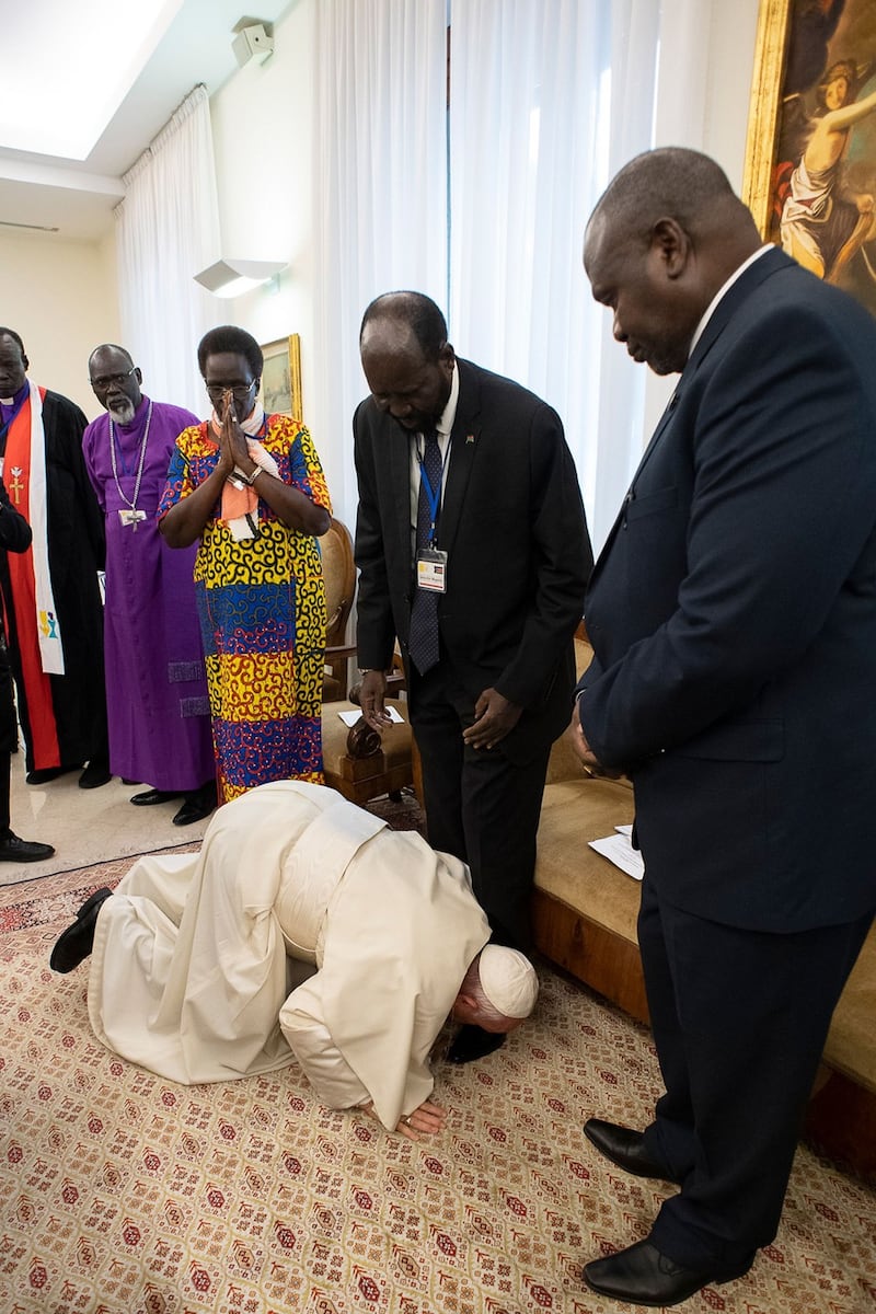 Pope Francis  kneels to kiss the feet of South Sudan’s president Salva Kiir. Photo Vatican Media/AFP/Getty