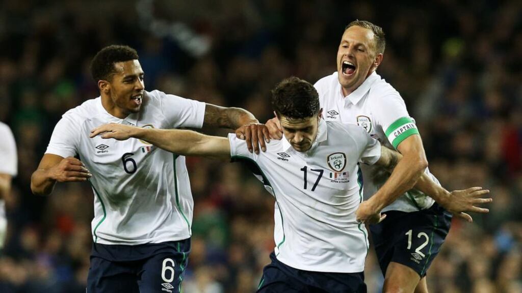 Republic of Ireland’s Robbie Brady (centre) celebrates with team-mates David Meyler (right) and Cyrus Christie after scoring his side’s fourth goal against teh USA. Photograph: Brian Lawless/PA Wire