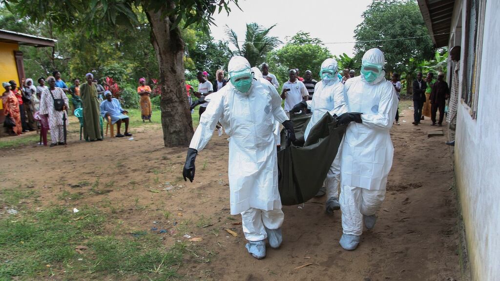 Liberian nurses carry the body of an Ebola victim in 2014. Vaccines were not available to victims of the epidemic, lobby group Access to Medicines Ireland says. Photograph: Ahmed Jallanzo/EPA