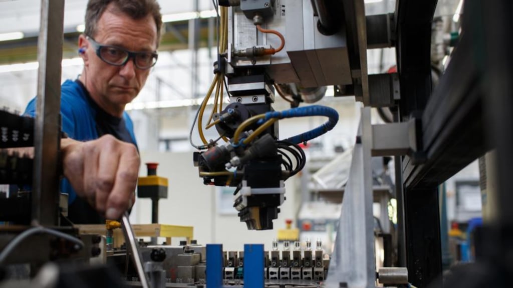 An employee works on the halogen light production line at the Royal Philips automotive lighting factory in Aachen, Germany. Photographer: Jasper Juinen/Bloomberg