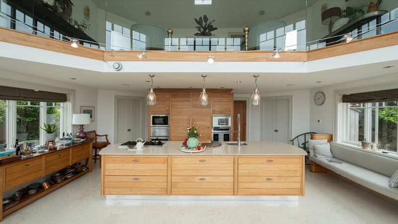 The kitchen, a vast double height space, spans the width of the property