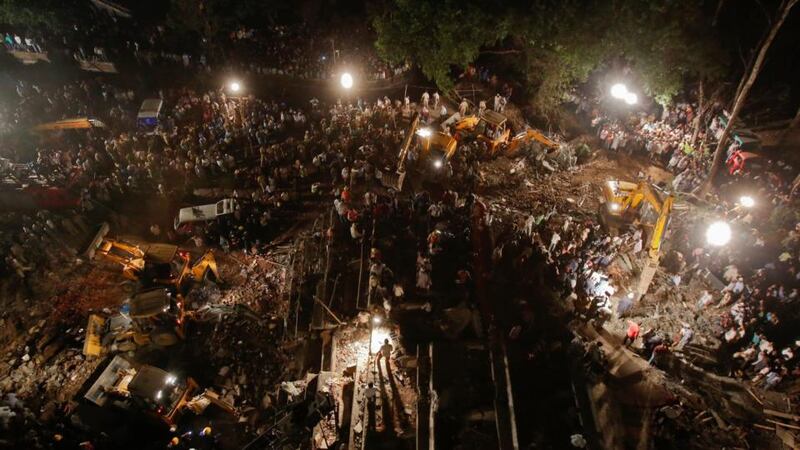 Rescue workers search for survivors at the site of the collapsed residential building in Thane on the outskirts of Mumbai. Photograph: Vivek Prakash/Reuters