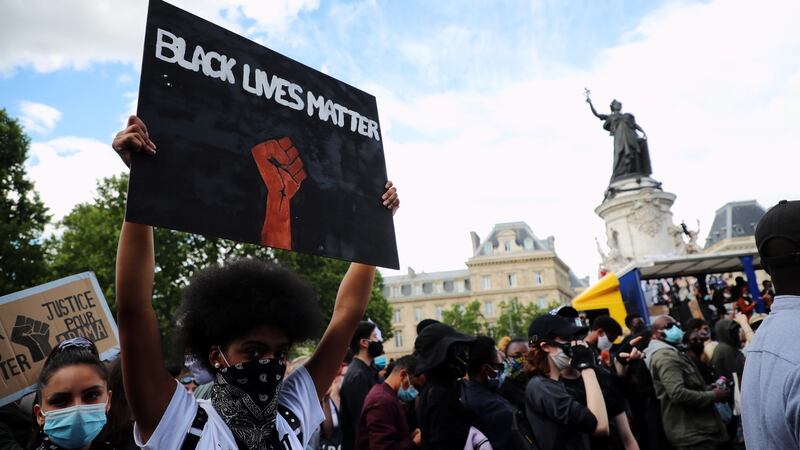 A protester holds a Black lives matter sign during a demonstration against police brutality and racism in Paris on Saturday. Photograph: Christophe Petit Tesson/EPA