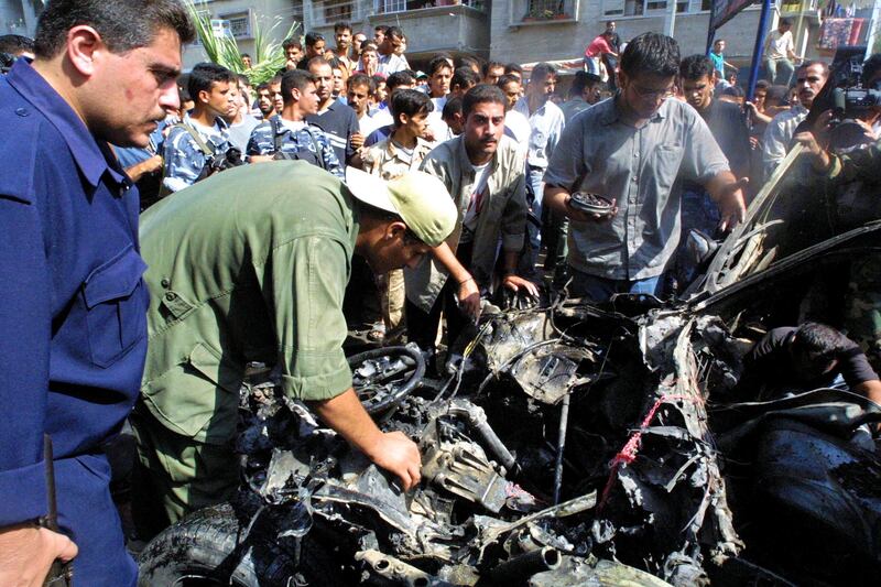 Palestinians inspect the wreckage of Mohammed Deif's car after it was fired on by Israeli helicopter missiles in 2002 in Gaza City. Photograph: Abid Katib/Getty Images