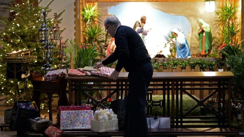 Canon Damien O’Reilly with unwanted and unused Christmas gifts, donated by people and distributed by Crosscare, at the Pro-Cathedral, Dublin. Photograph: Eric Luke