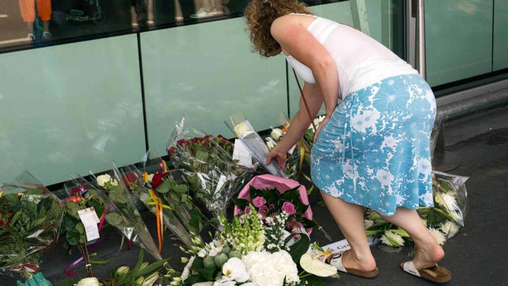 A woman lays flowers today outside the departure hall at Schiphol Airport in the wake of the downing of the Malaysian Airlines Boeing 777 in Ukraine. Photograph: Michael Kooren/Reuters