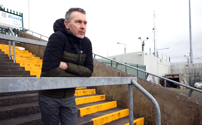 Former Armagh footballer Oisín McConville on the terrace of the Crossmaglen Rangers pitch which is overlooked by the still heavily fortified police station. Photograph: Stephen Davison