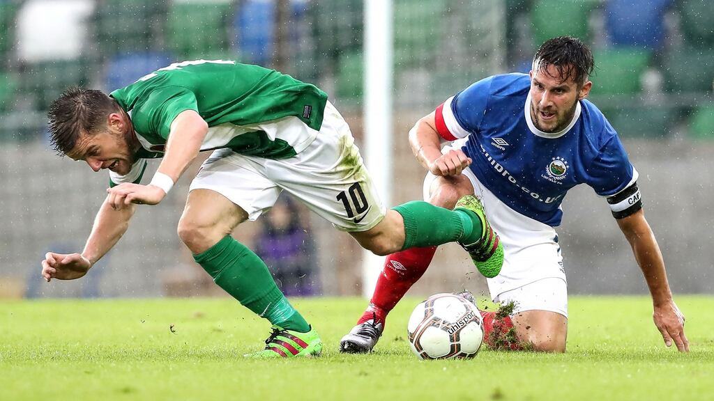 Linfield’s Andrew Waterworth gets the better of Cork’s Steven Beattie. Photo: William Cherry/Inpho