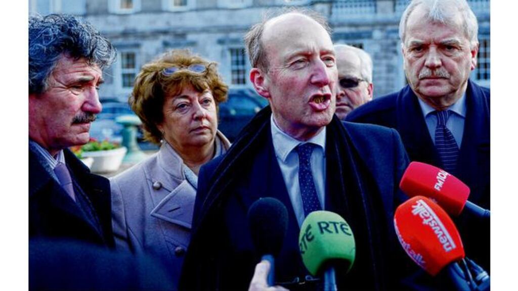 Fellow Independent TDs gathering outside Leinster House yesterday to voice their support for Shane Ross's proposal on the promissory note issue. Mr Ross has called on the Government to declare it will not pay the €3.1 billion that is due next month. photograph: bryan o'brien