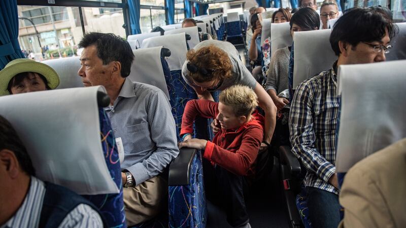 Marieke Vervoort is helped by her nurse into a tour bus seat while fulfilling her dream of visiting Japan, in Kyoto, April 2017. Photograph: Lynsey Addario/New York Times