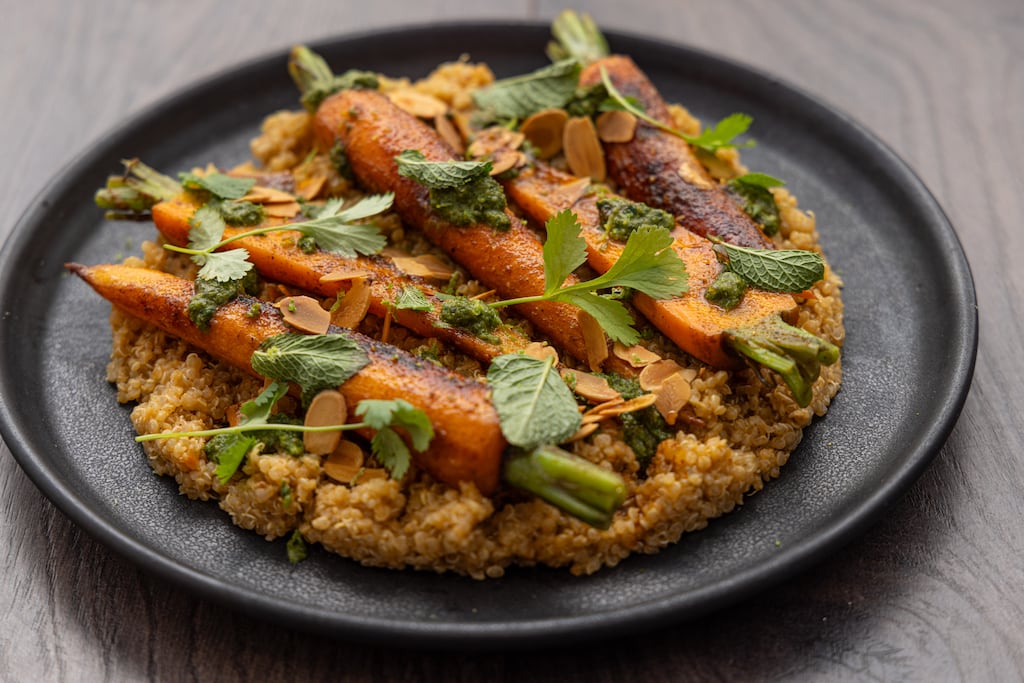 Carrots roasted in spiced butter with quinoa, salsa verde and toasted almonds. Photograph: Harry Weir