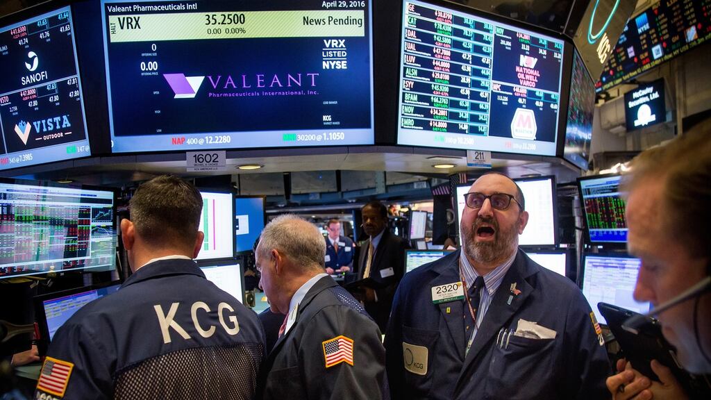 Traders by a monitor displaying Valeant Pharmaceuticals International signage at the New York Stock Exchange. Photograph: Michael Nagle/Bloomberg