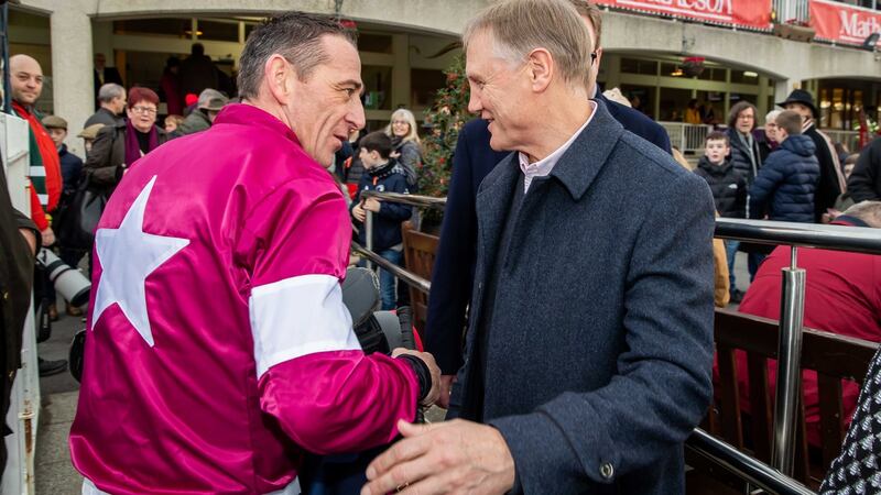 Davy Russell is congratulated by Joe Schmidt after winning the Neville Hotels Novice Steeplechase on Battleoverdoyen. Photograph: Morgan Treacy/Inpho