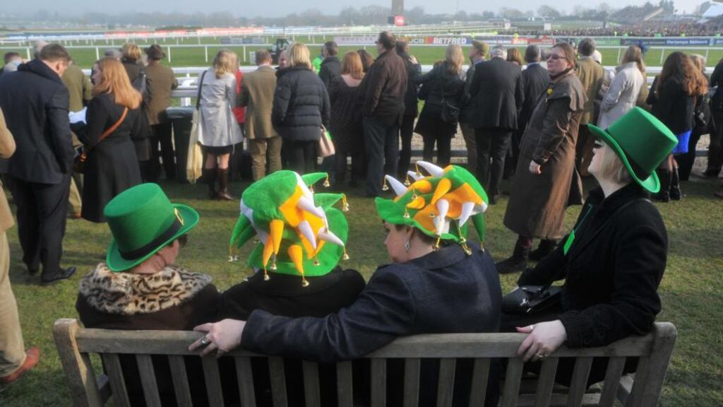 Racegoers rest their feet during St Patrick’s Thursday at Cheltenham. Photograph: Tim Ireland/PA Wire