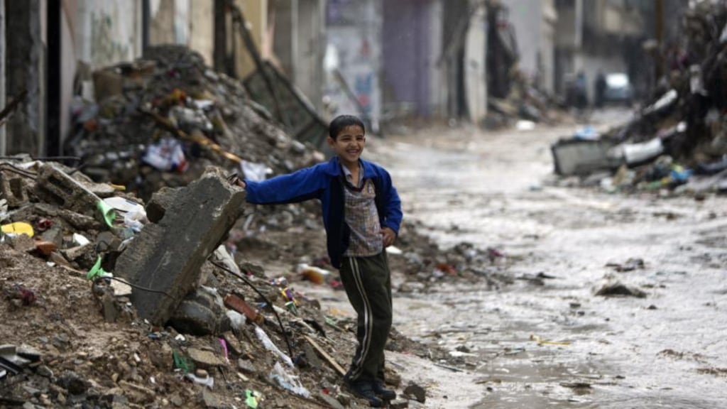 A Palestinian boy next to the rubble of buildings destroyed during the 50 days of conflict between Israel and Hamas in 2014, in Gaza City. Photograph: MAHMUD HAMS/AFP/Getty Images