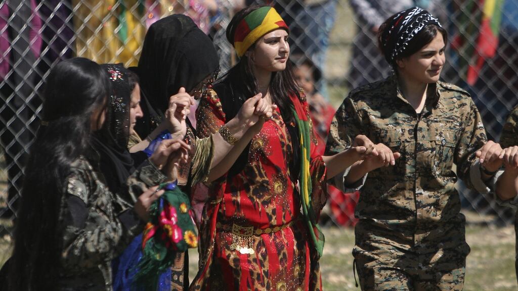 Kurdish women fighters from the People’s Protection Units (YPG) and women wearing traditional dress celebrating the spring festival of Newroz in the Kurdish city of Qamishli, Syria. Photograph: Rodi Said/Reuters