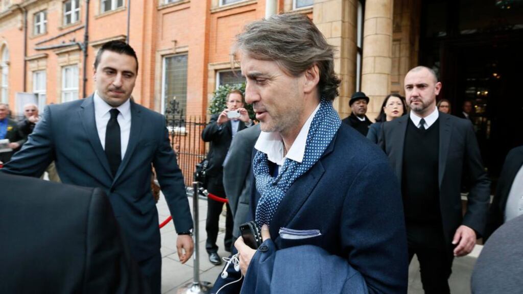 Former Manchester City manager Roberto Mancini leaves the team hotel in London. City sacked the Italian last night after his team’s feeble defence of the Premier League title they won exactly one year ago. Photograph: Stefan Wermuth/Reuters