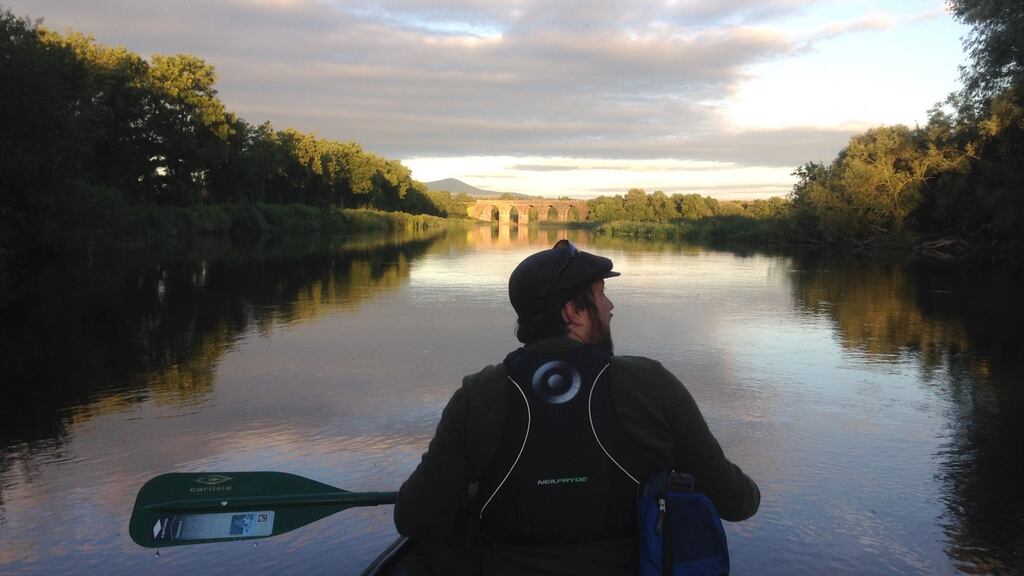 Dan paddles down the Barrow river in an open-top Canadian canoe