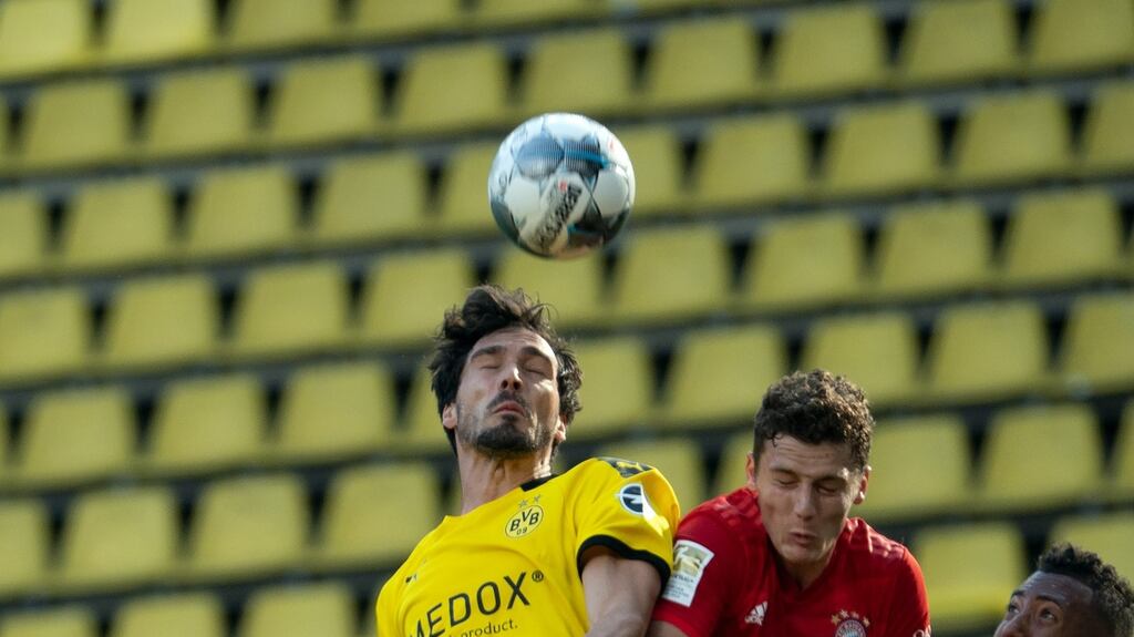 Bayern Munich’s Benjamin Pavard and Borussia Dortmund’s Thomas Delaney challenge for a header during the Bundesliga clash. Photo: Federico Gambarini/AFP via Getty Images
