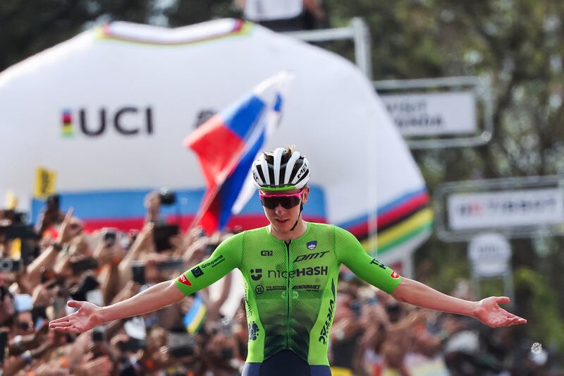 Tadej Pogacar celebrates as he crosses the finish line to win the men's road race. Photograph: Anne-Christine Poujoulat/AFP via Getty Images