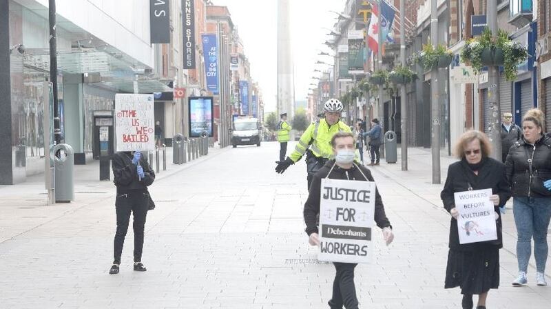 Debenhams workers gathered to protest outside the store on Henry Street, Dublin, were asked to move by gardaí. Photograph: Dara Mac Dónaill
